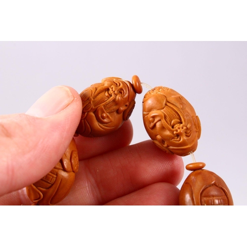 150 - A CHINESE CARVED NUT BRACELET.