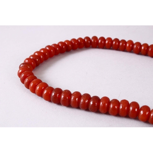 151 - A CHINESE AGATE BEAD NECKLACE, the bead approx 8mm diameter.