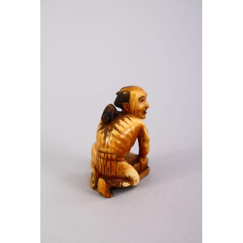 162 - A JAPANESE MEIJI PERIOD CARVED IVORY SMALL OKIMONO OF A RAT CATCHER, the man leaning over his trap w... 