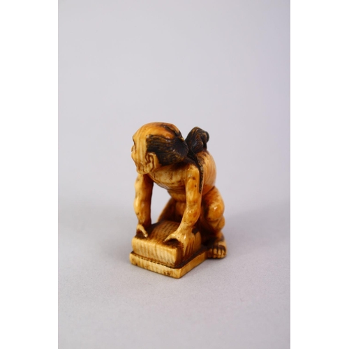 162 - A JAPANESE MEIJI PERIOD CARVED IVORY SMALL OKIMONO OF A RAT CATCHER, the man leaning over his trap w... 