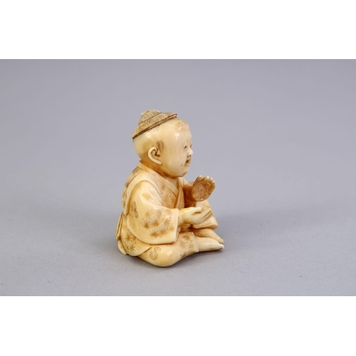 163 - A JAPANESE MEIJI PERIOD CARVED IVORY NETSUKE OF A BOY, the boy in a seated position clapping his han... 