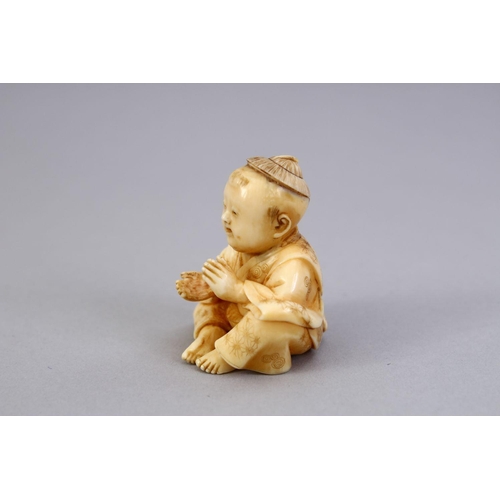 163 - A JAPANESE MEIJI PERIOD CARVED IVORY NETSUKE OF A BOY, the boy in a seated position clapping his han... 