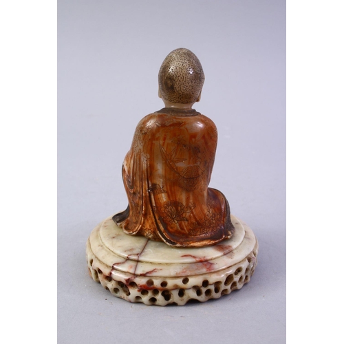 186 - A GOOD CHINESE CARVED SOAPSTONE FIGURE OF ROHAN, in a seated position holding a vessel, with a carve... 