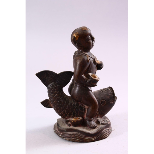 190 - A SMALL CHINESE BRONZE FIGURE OF A BOY SEATED UPON A CARP, 15cm high.