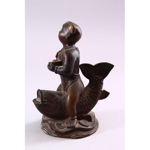 190 - A SMALL CHINESE BRONZE FIGURE OF A BOY SEATED UPON A CARP, 15cm high.