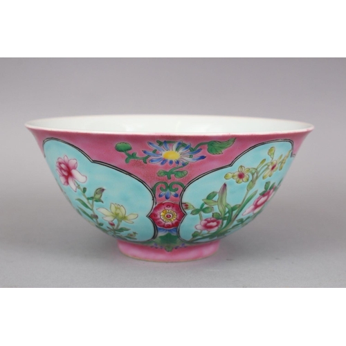 206 - A CHINESE PINK GROUND FAMILLE ROSE PORCELAIN BOWL, with panels of native flora on a blue ground, the... 