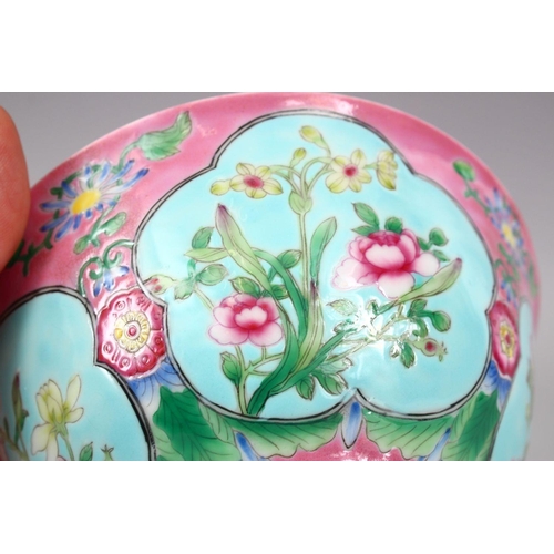 206 - A CHINESE PINK GROUND FAMILLE ROSE PORCELAIN BOWL, with panels of native flora on a blue ground, the... 