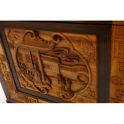 234 - A GOOD 20TH CENTURY CHINESE CARVED CAMPHORWOOD CHEST, the top and sides well carved with figures in ... 