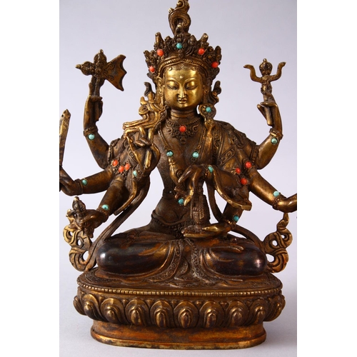 236 - A GOOD TIBETAN GILT BRONZE FIGURE OF A MULTI ARMED DIETY, inlaid with semi precious stones, 22.5cm h... 