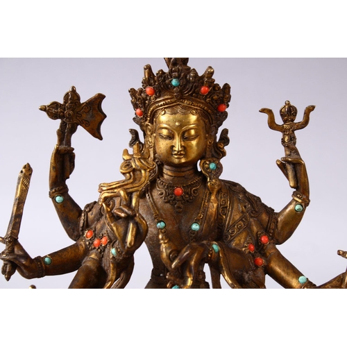 236 - A GOOD TIBETAN GILT BRONZE FIGURE OF A MULTI ARMED DIETY, inlaid with semi precious stones, 22.5cm h... 