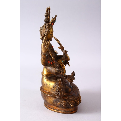 236 - A GOOD TIBETAN GILT BRONZE FIGURE OF A MULTI ARMED DIETY, inlaid with semi precious stones, 22.5cm h... 