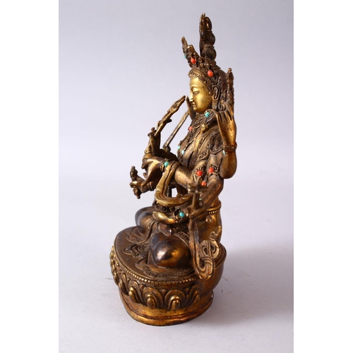 236 - A GOOD TIBETAN GILT BRONZE FIGURE OF A MULTI ARMED DIETY, inlaid with semi precious stones, 22.5cm h... 