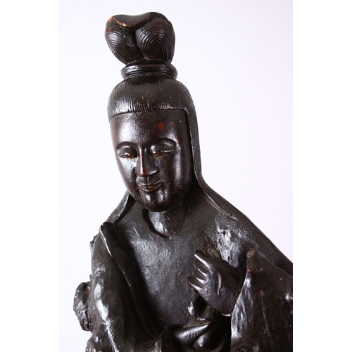 237 - A LARGE ROOTWOOD CARVING OF GUANYIN, the base with naturalistic form, 102cm high, 38cm wide.