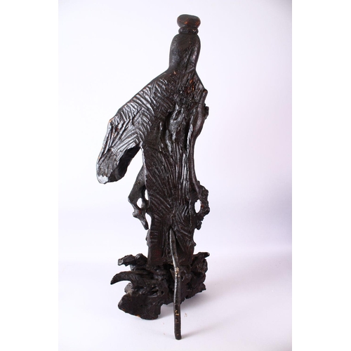 237 - A LARGE ROOTWOOD CARVING OF GUANYIN, the base with naturalistic form, 102cm high, 38cm wide.