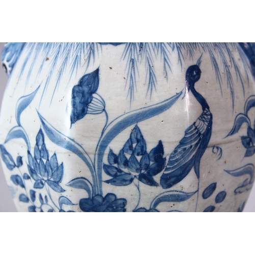 242 - A CHINESE YUAN STYLE BLUE & WHITE TWIN HANDLE PORCELAIN VASE, decorated with scenes of cranes amongs... 