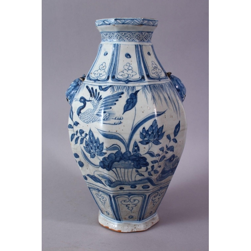 242 - A CHINESE YUAN STYLE BLUE & WHITE TWIN HANDLE PORCELAIN VASE, decorated with scenes of cranes amongs... 