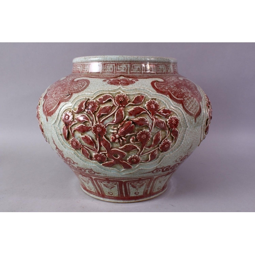 249 - A LARGE CHINESE MING STYLE COPPER RED CARVED PORCELAIN VASE, with carved flroal panels and border de... 