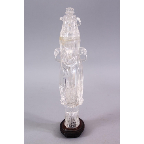 266 - AN 18TH CENTURY CHINESE CARVED ROCK CRYSTAL VASE AND COVER, with rams head and ring handles, with fl... 