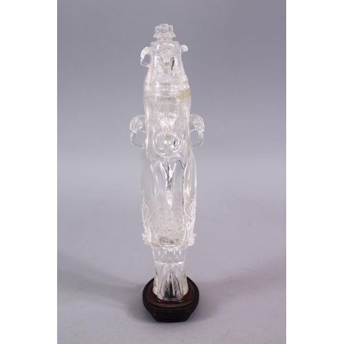 266 - AN 18TH CENTURY CHINESE CARVED ROCK CRYSTAL VASE AND COVER, with rams head and ring handles, with fl... 