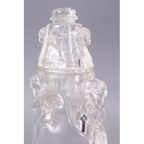 266 - AN 18TH CENTURY CHINESE CARVED ROCK CRYSTAL VASE AND COVER, with rams head and ring handles, with fl... 