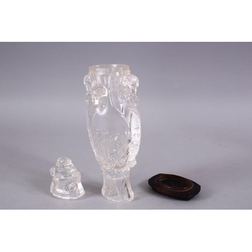 266 - AN 18TH CENTURY CHINESE CARVED ROCK CRYSTAL VASE AND COVER, with rams head and ring handles, with fl... 