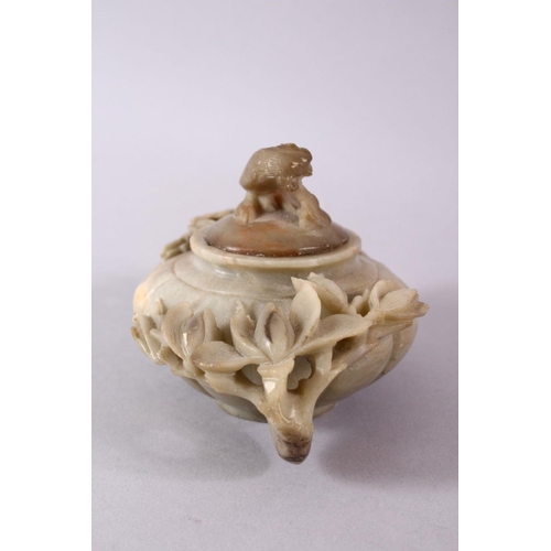 28 - A CHINESE CARVED SOAPSTONE PHOENIX TEAPOT, carved with relief flora around the ribbed body, with a c... 