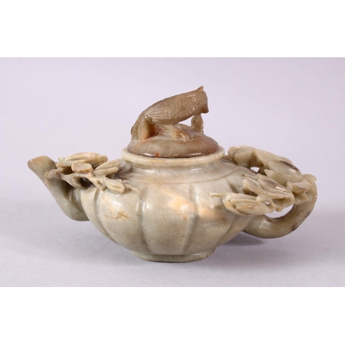 28 - A CHINESE CARVED SOAPSTONE PHOENIX TEAPOT, carved with relief flora around the ribbed body, with a c... 