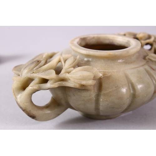 28 - A CHINESE CARVED SOAPSTONE PHOENIX TEAPOT, carved with relief flora around the ribbed body, with a c... 