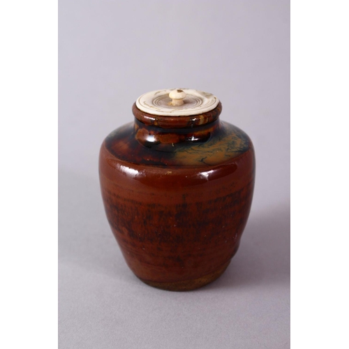 290 - A JAPANESE MEIJI PERIOD POTTERY TEA CADDY / JAR AND IVORY COVER, with a drip glaze base and ivory co... 