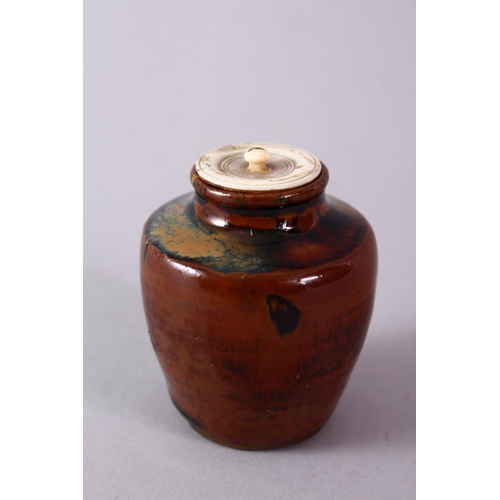 290 - A JAPANESE MEIJI PERIOD POTTERY TEA CADDY / JAR AND IVORY COVER, with a drip glaze base and ivory co... 