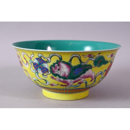 309 - A CHINESE FAMILLE JAUNE QIANLONG STYLE PORCELAIN LION DOG BOWL, decorated upon a yellow ground with ... 