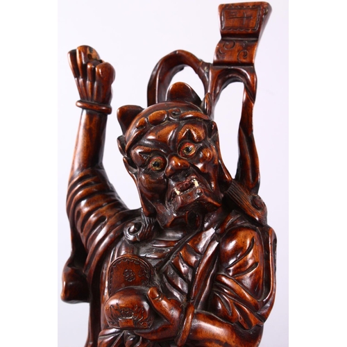 313 - A LARGE 19TH CENTURY CHINESE CARVED HARDWOOD FIGURE OF A DEVIL, stood upon a wave formed base with i... 