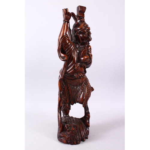 313 - A LARGE 19TH CENTURY CHINESE CARVED HARDWOOD FIGURE OF A DEVIL, stood upon a wave formed base with i... 