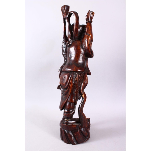 313 - A LARGE 19TH CENTURY CHINESE CARVED HARDWOOD FIGURE OF A DEVIL, stood upon a wave formed base with i... 