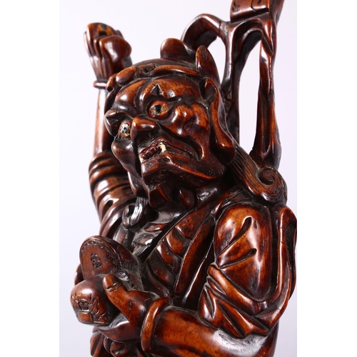 313 - A LARGE 19TH CENTURY CHINESE CARVED HARDWOOD FIGURE OF A DEVIL, stood upon a wave formed base with i... 