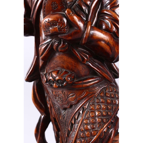 313 - A LARGE 19TH CENTURY CHINESE CARVED HARDWOOD FIGURE OF A DEVIL, stood upon a wave formed base with i... 