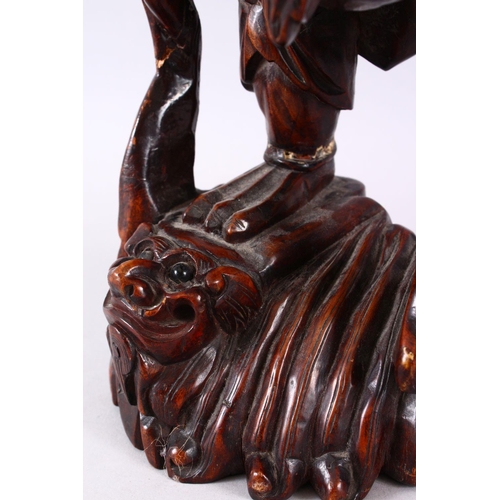 313 - A LARGE 19TH CENTURY CHINESE CARVED HARDWOOD FIGURE OF A DEVIL, stood upon a wave formed base with i... 