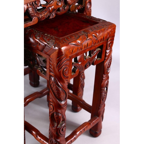 325 - A FINE 19TH / 20TH CENTURY CHINESE CARVED HARD WOOD NEST OF FOUR DRAGON & BAT TABLES, the tops with ... 