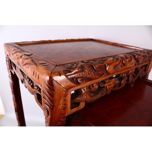 325 - A FINE 19TH / 20TH CENTURY CHINESE CARVED HARD WOOD NEST OF FOUR DRAGON & BAT TABLES, the tops with ... 