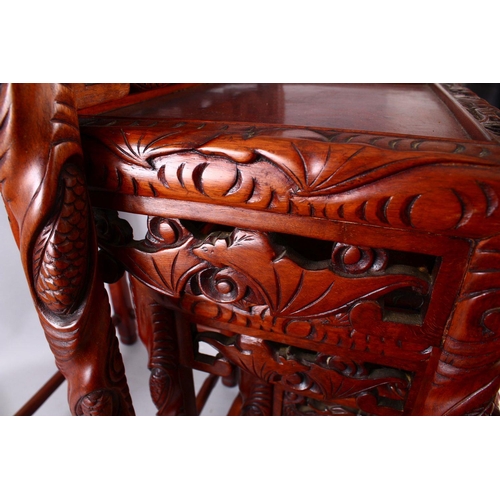 325 - A FINE 19TH / 20TH CENTURY CHINESE CARVED HARD WOOD NEST OF FOUR DRAGON & BAT TABLES, the tops with ... 