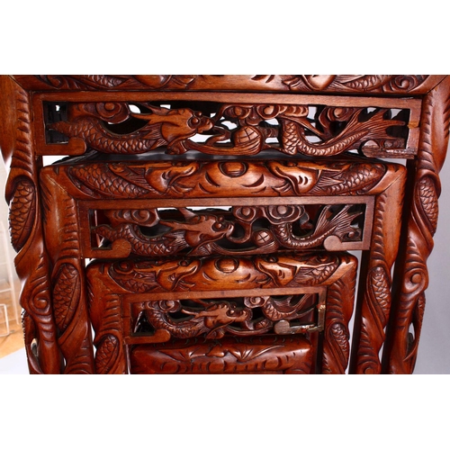 325 - A FINE 19TH / 20TH CENTURY CHINESE CARVED HARD WOOD NEST OF FOUR DRAGON & BAT TABLES, the tops with ... 