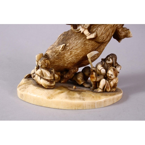 34 - A JAPANESE MEIJI PERIOD CARVED IVORY OKIMONO GROUP- depicting a boar being attacked by numerous figu... 