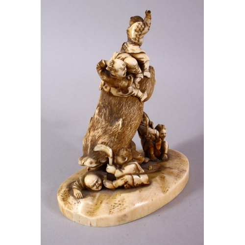 34 - A JAPANESE MEIJI PERIOD CARVED IVORY OKIMONO GROUP- depicting a boar being attacked by numerous figu... 