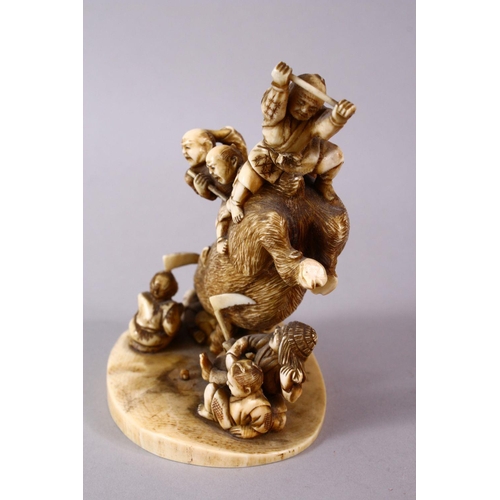 34 - A JAPANESE MEIJI PERIOD CARVED IVORY OKIMONO GROUP- depicting a boar being attacked by numerous figu... 