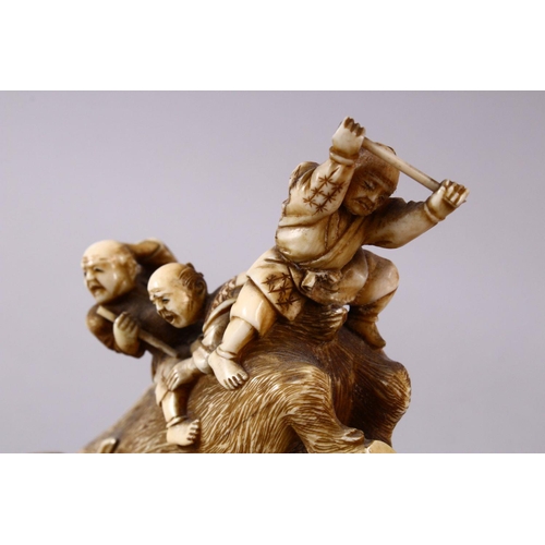 34 - A JAPANESE MEIJI PERIOD CARVED IVORY OKIMONO GROUP- depicting a boar being attacked by numerous figu... 