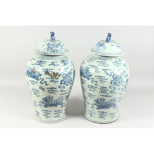 341 - A PAIR OF 20TH CENTURY CHINESE BLUE AND WHITE BALUSTER SHAPE TEMPLE JARS AND COVERS, painted with li... 