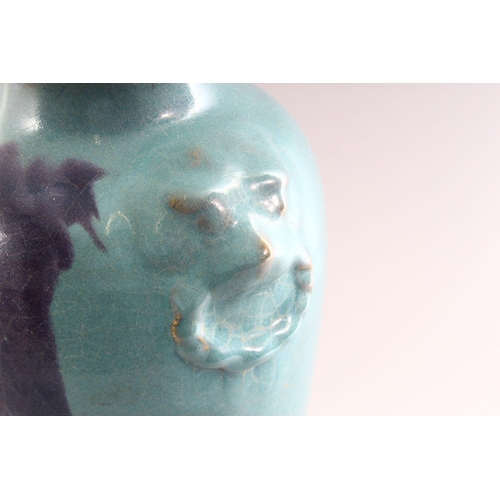 345 - A CHINESE PURPLE SPLASH POTTERY VASE, with moulded lion mask handles, 35cm high.