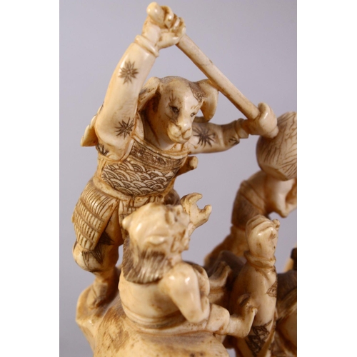 35 - A JAPANESE MEIJI PERIOD CARVED IVORY OKIMONO GROUP - depicting figures attacking oni demons, one dog... 