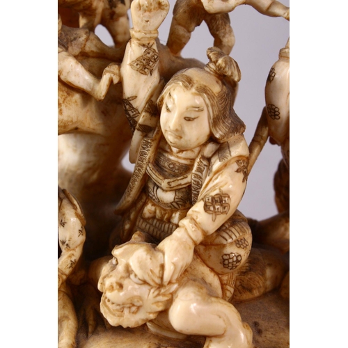 35 - A JAPANESE MEIJI PERIOD CARVED IVORY OKIMONO GROUP - depicting figures attacking oni demons, one dog... 