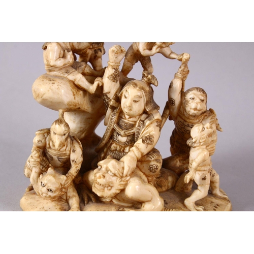 35 - A JAPANESE MEIJI PERIOD CARVED IVORY OKIMONO GROUP - depicting figures attacking oni demons, one dog... 